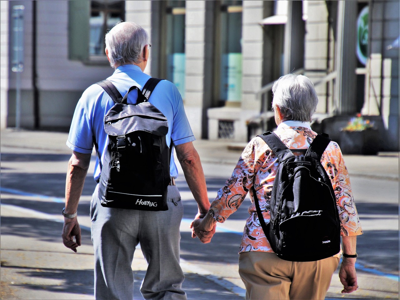 Older couple walking outdoors smiling
