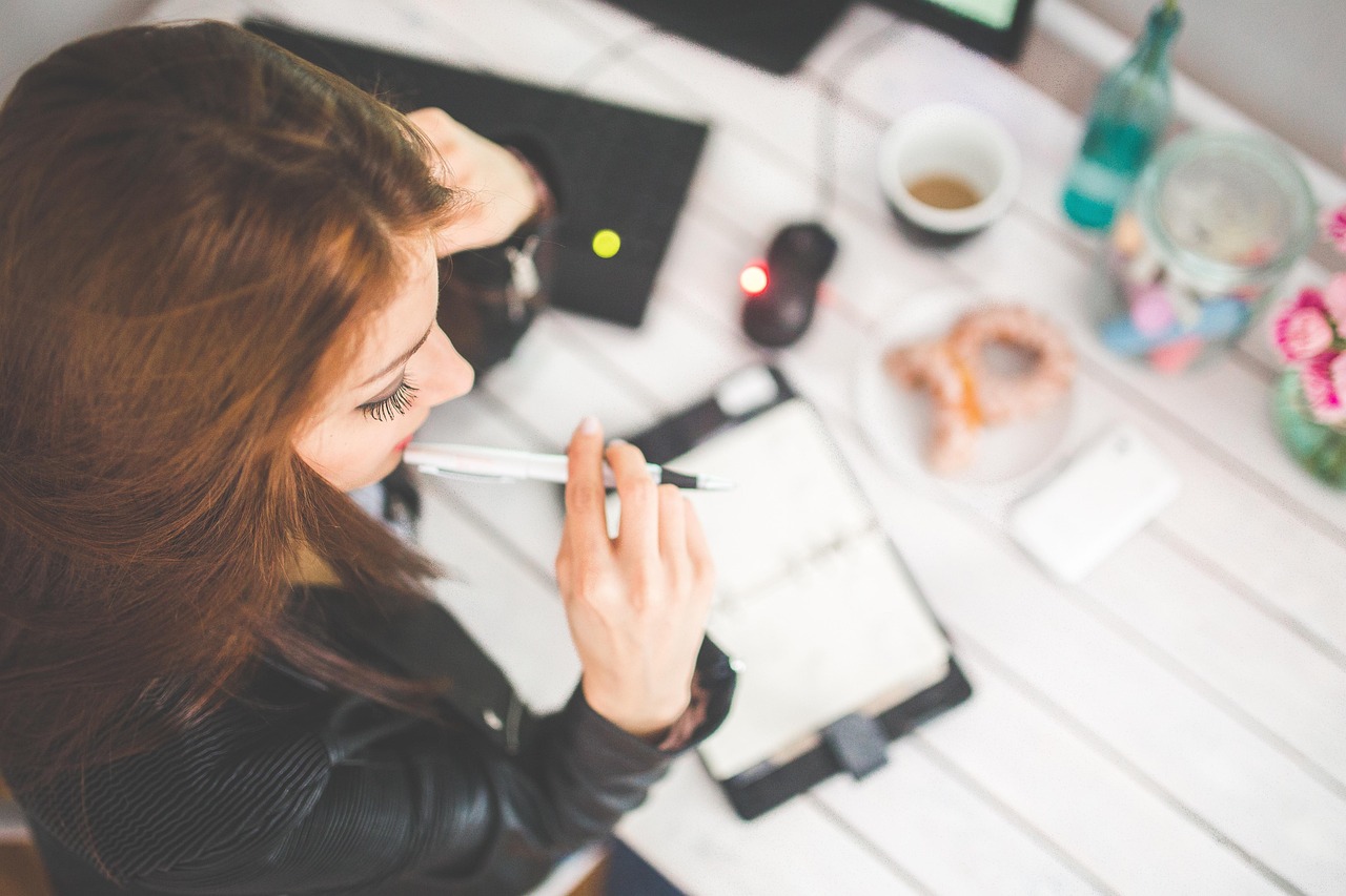 Woman writing down a household budget